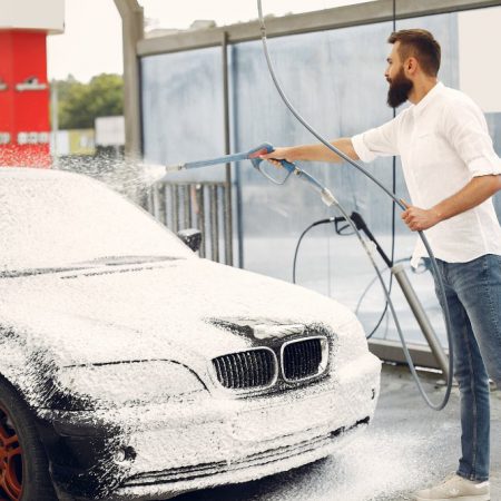 man-washing-his-car-washing-station